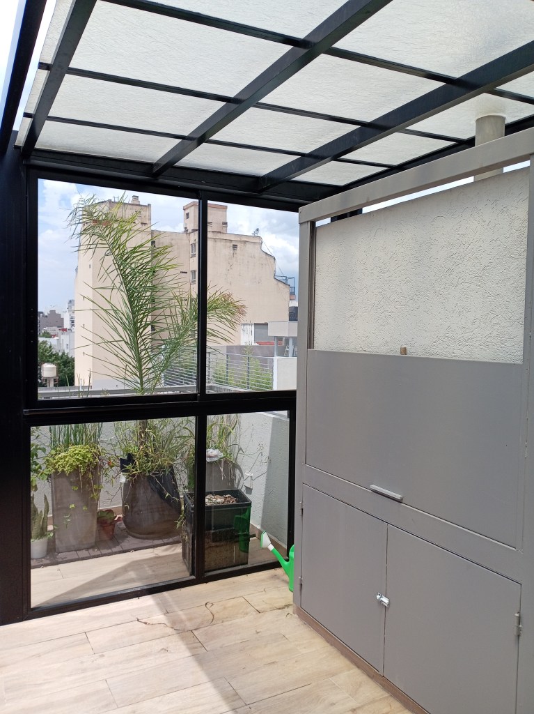 Aberturas de aluminio para cerramiento con vidrios de seguridad y techo translucido fijo de poliacrílico antigranizo en terraza de Nuñez, Ciudad de Buenos Aires